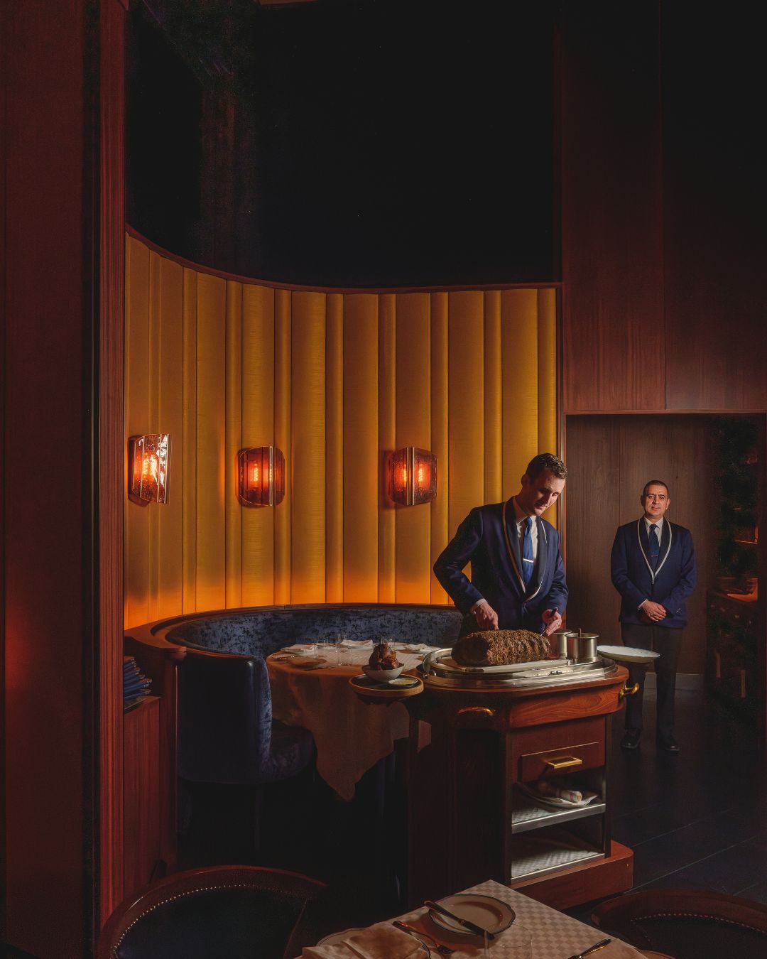 Elegant interior of La Tête d'Or by Daniel, featuring a table setting and attentive staff. A blend of luxury and comfort.